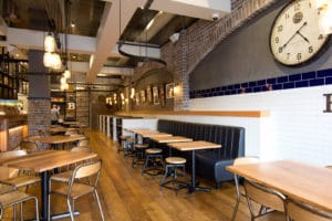 Ribs & Burgers dining area with wall clock and lighting