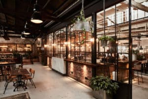 Stomping Ground Restaurant Seating area with industrial lighting and indoor plants