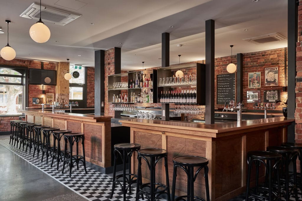 The Rose Hotel wooden bar with original brick work
